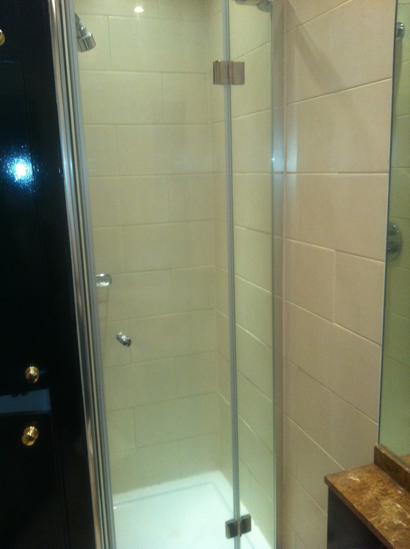 Frameless glass shower enclosure with chrome fittings in Brentford