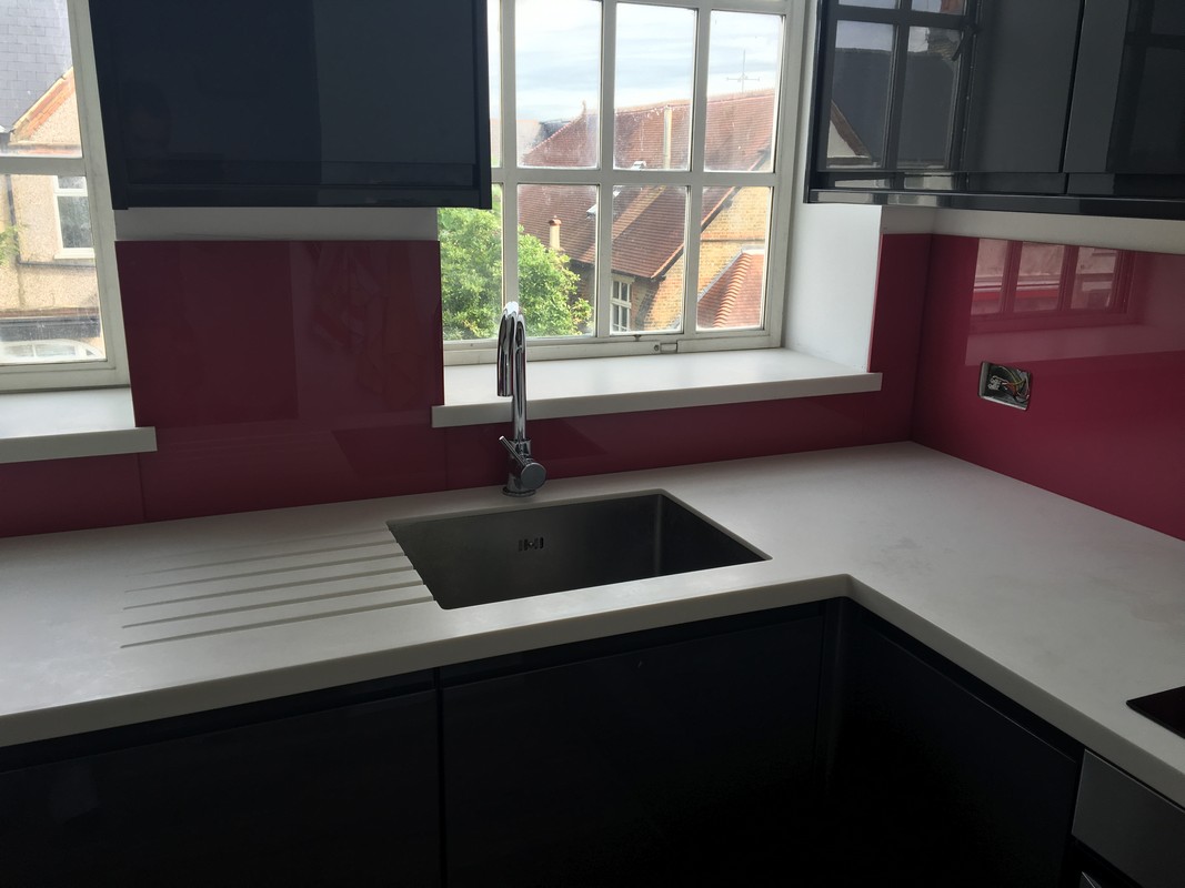 Deep plum coloured glass splashback in modern Brentford kitchen